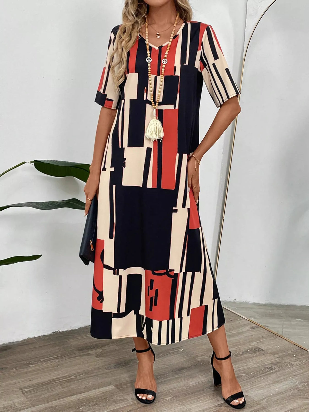 Abstract geometric print v neck midi dress close up view
