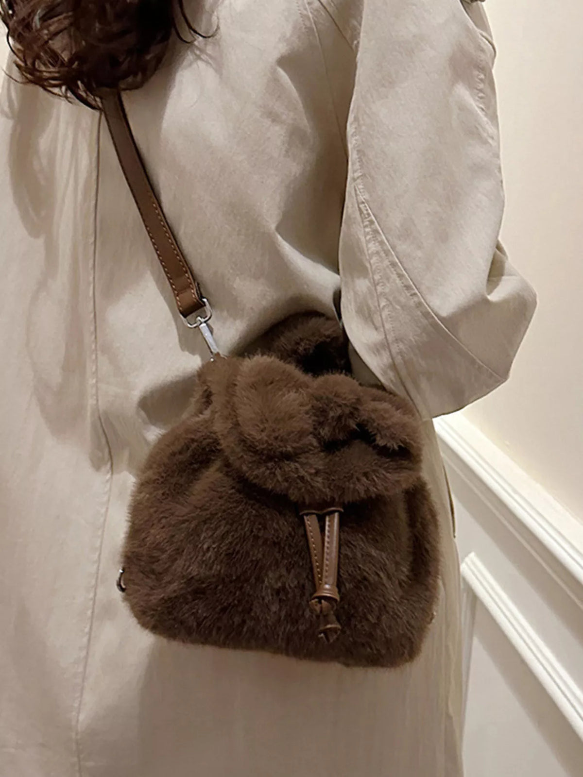 Black fuzzy drawstring backpack view