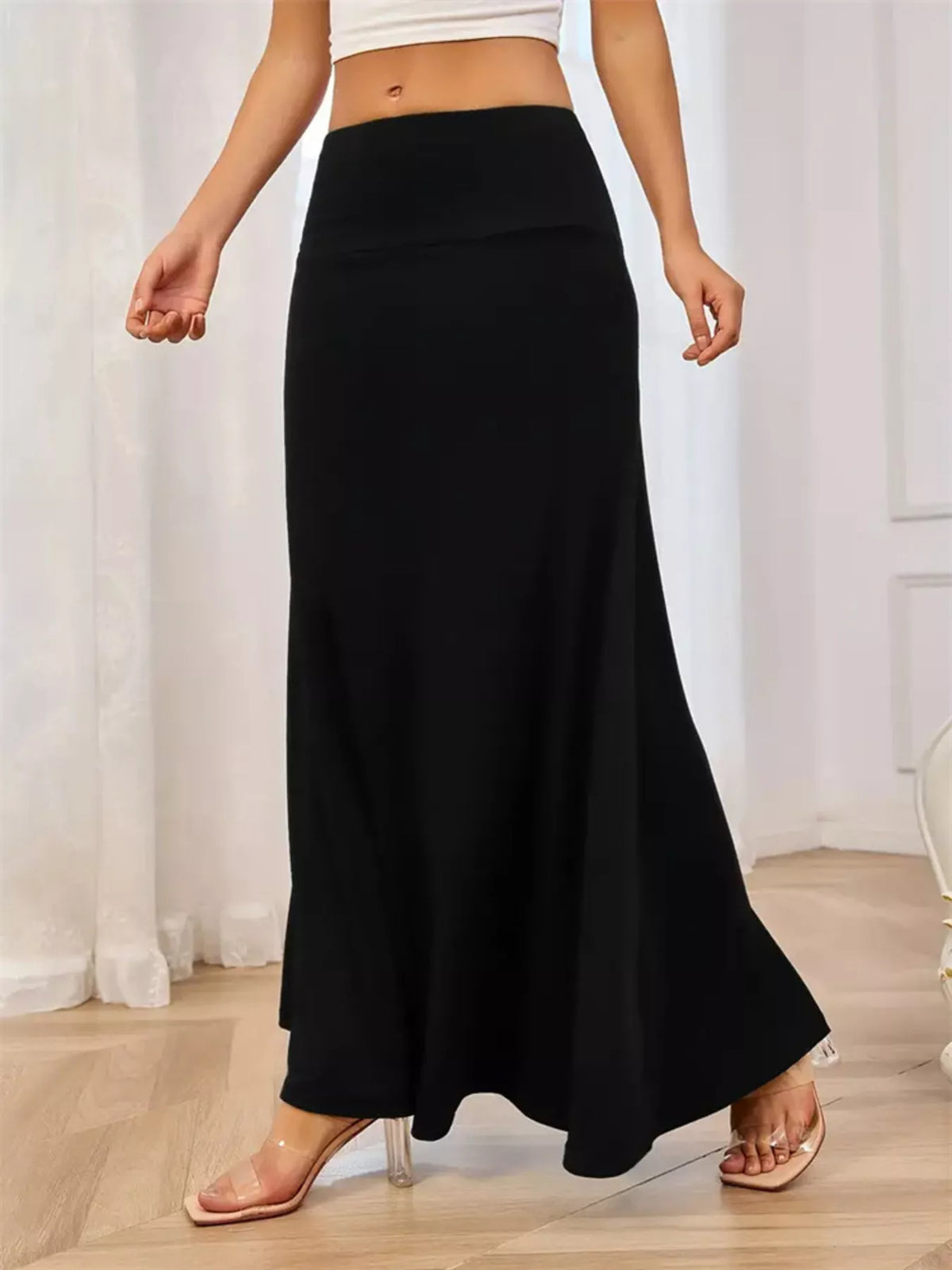 Close view of the wide waistband on the flowy maxi skirt