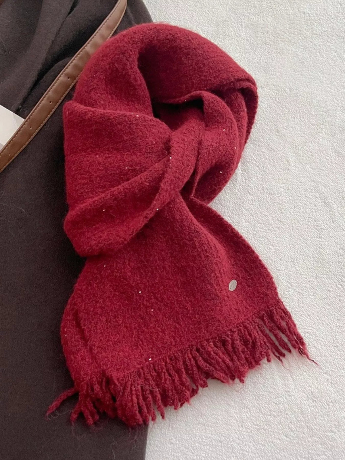 Knitted fringe scarf styled for cold weather
