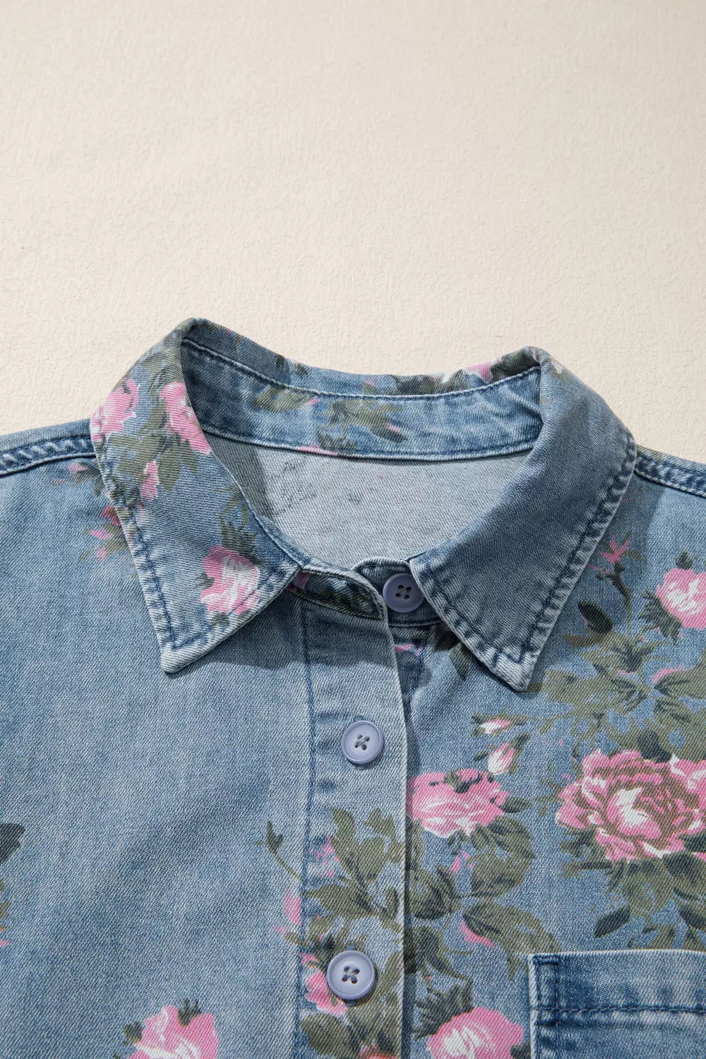 Button placket and pocket detail on the denim shirt