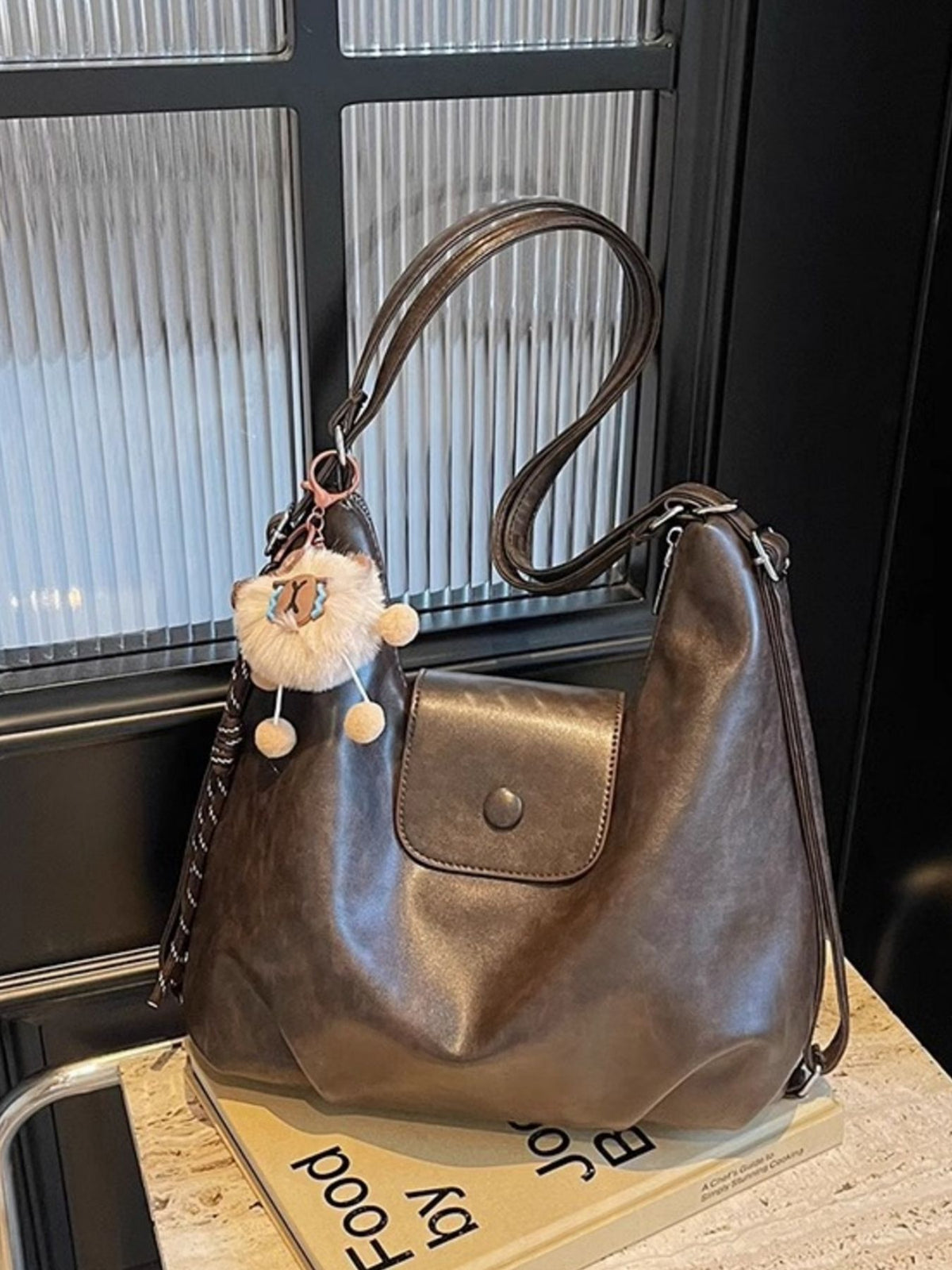 Adjustable strap detail on coffee brown bag