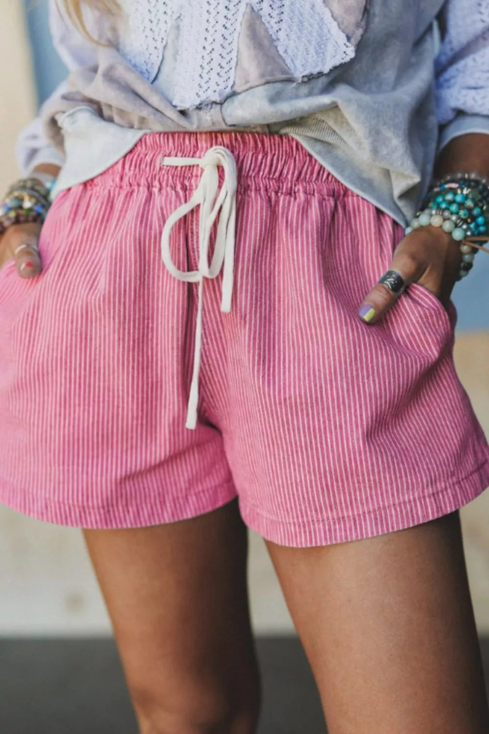 Pink striped elastic waist shorts, front view