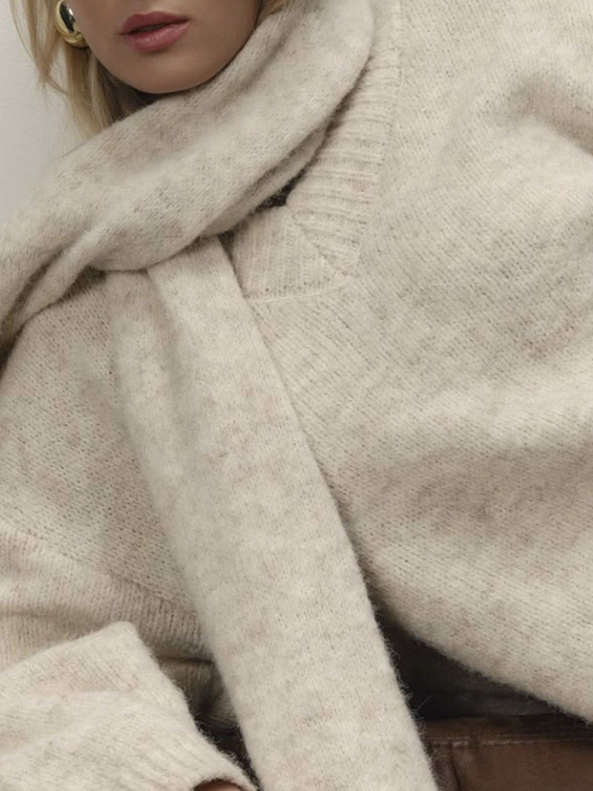 Matching scarf styling detail on sweater