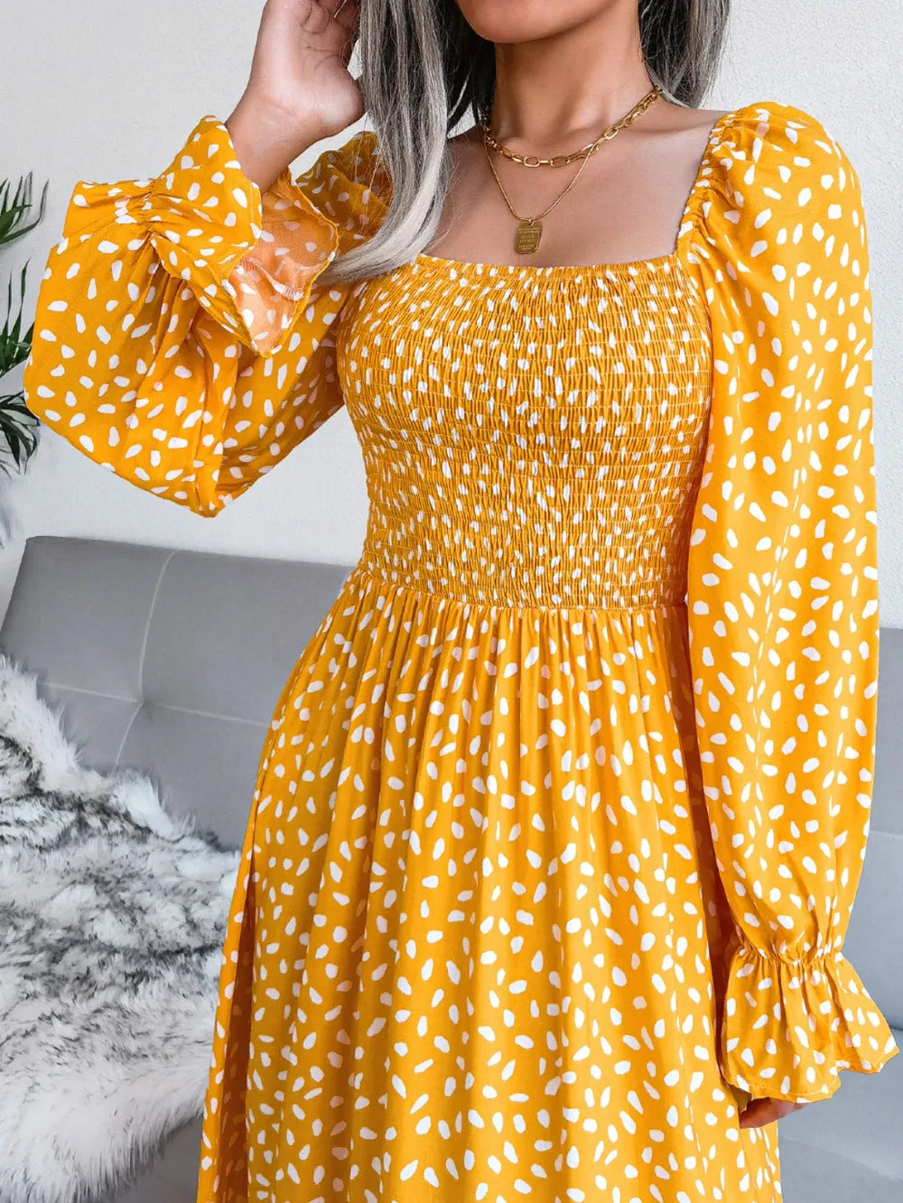 Smocked square neck flounce sleeve dress detail of the neckline