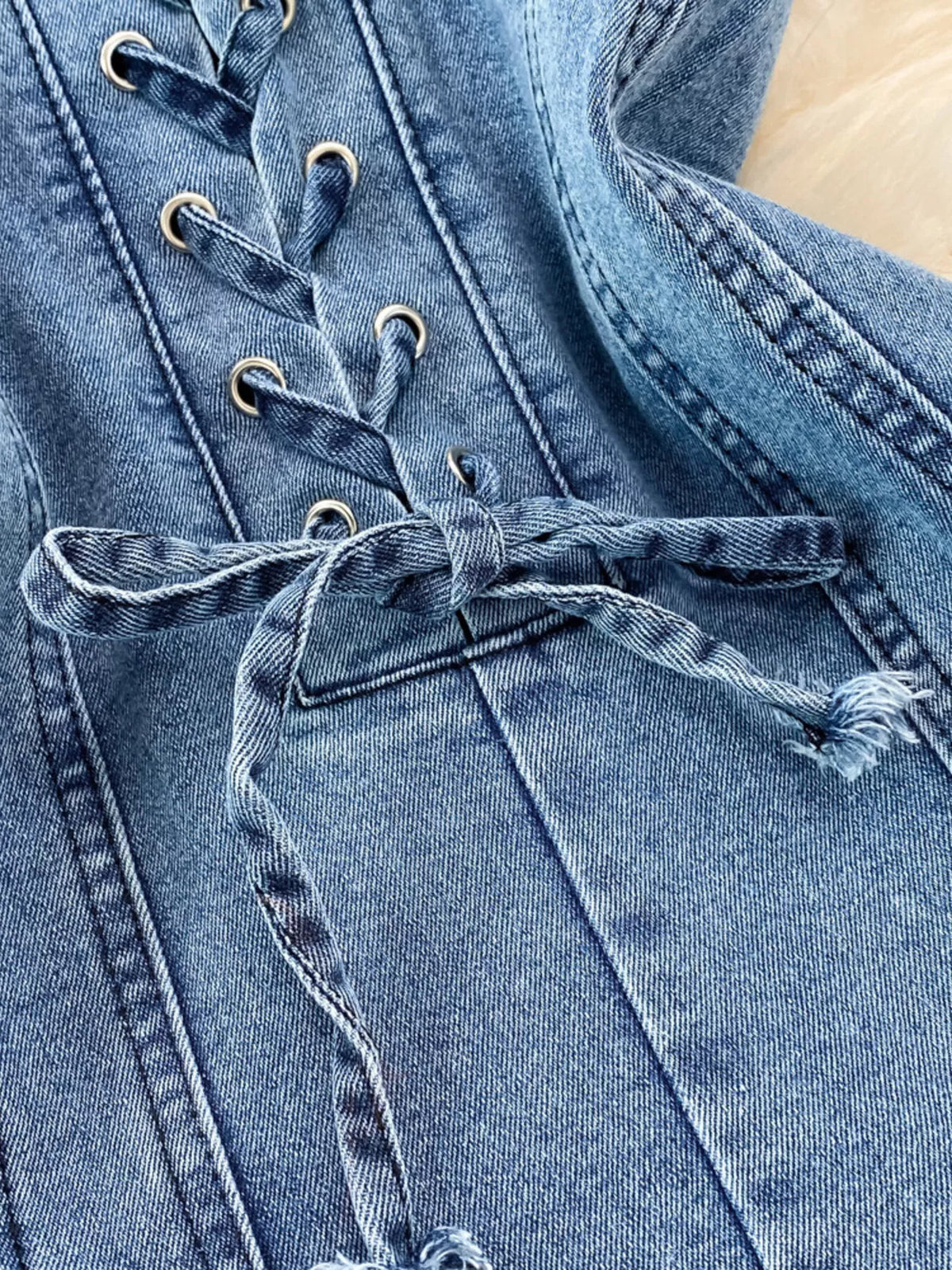 Blue lace up denim A line mini dress fabric detail