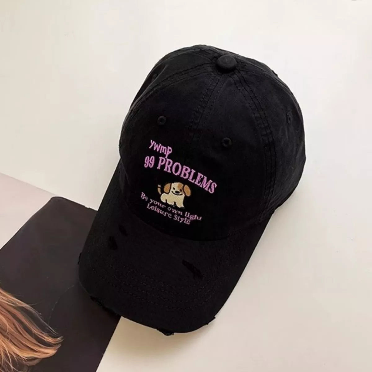 Distressed dog cap crown and brim detail
