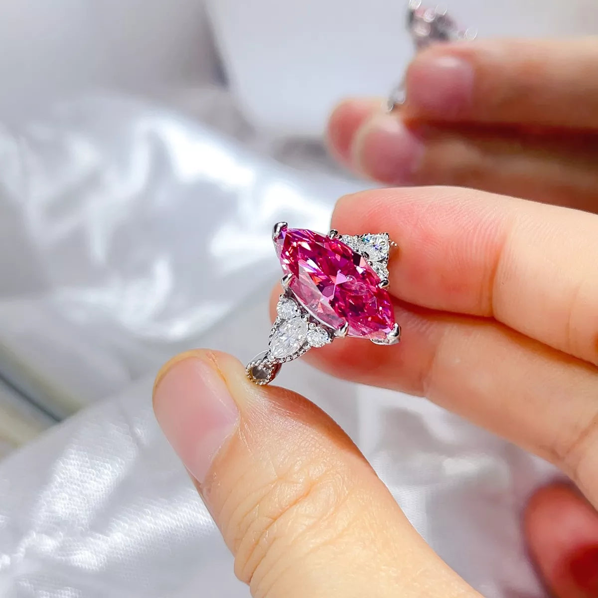 Pink moissanite ring worn on hand showing stone scale