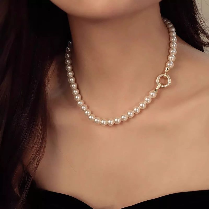 Cream pearl necklace with gold interlocking clasp front view