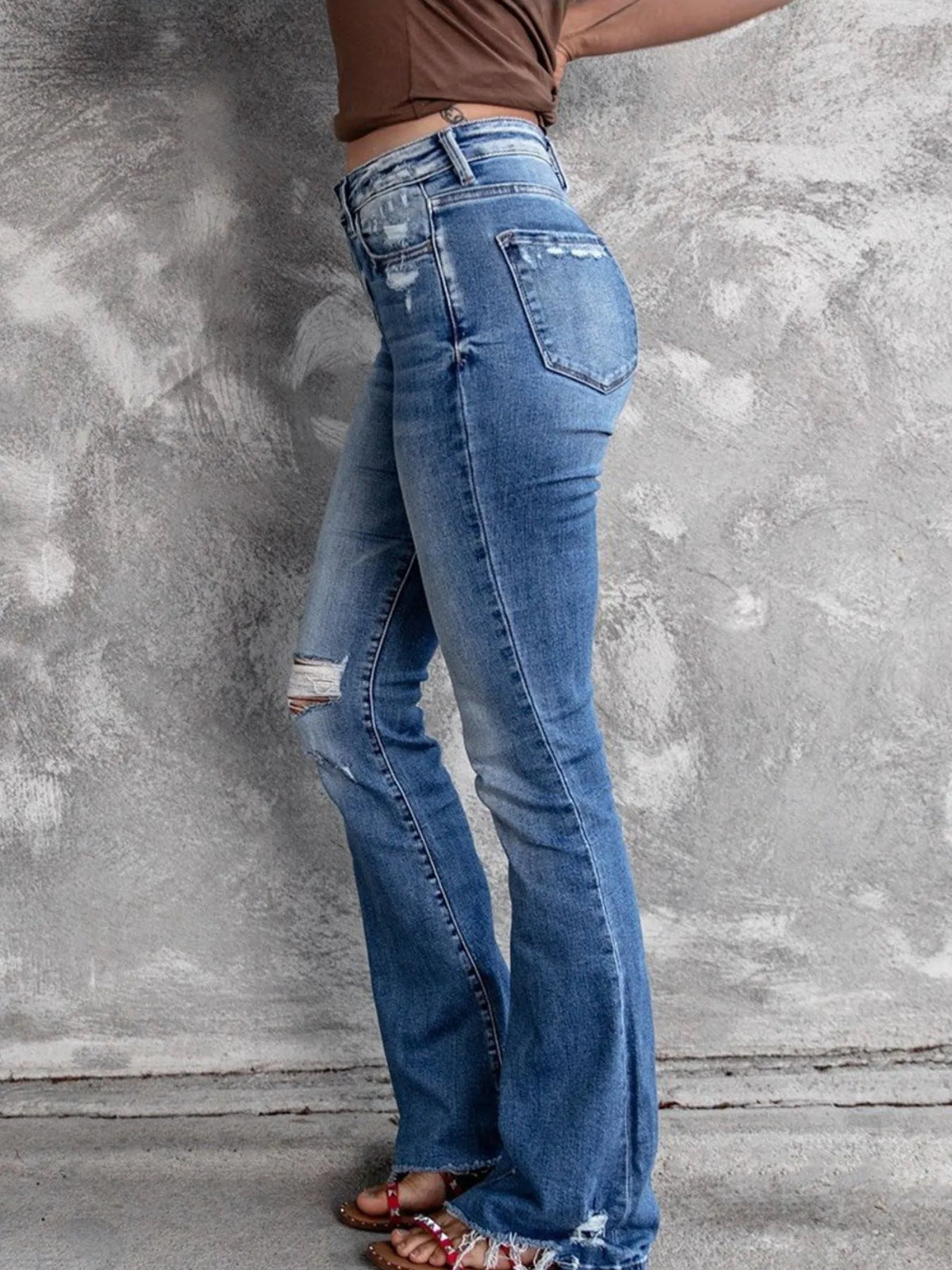Medium wash distressed flare jeans full length