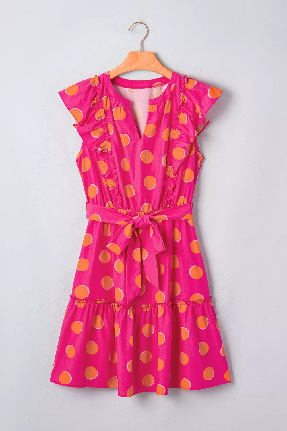 Deep rose polka dot dress hem and length detail