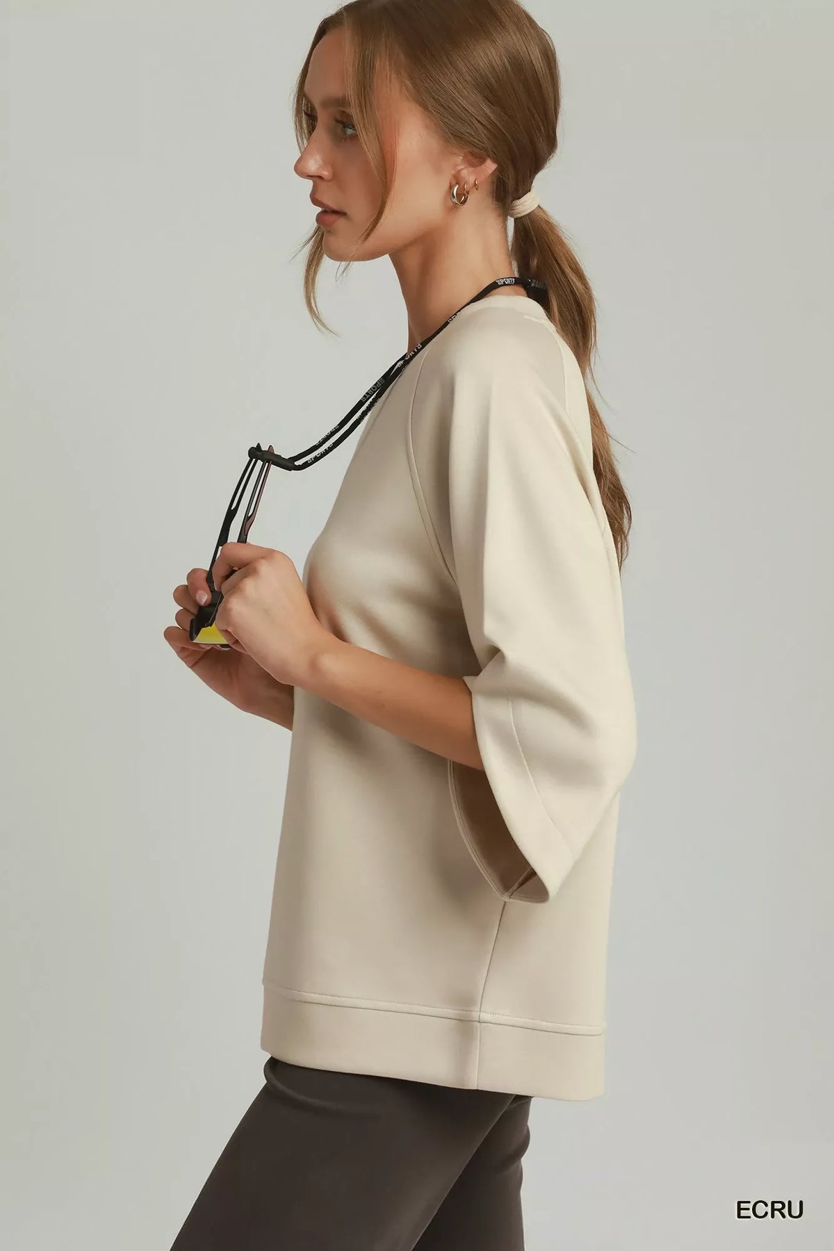 Round hem detail on knit top