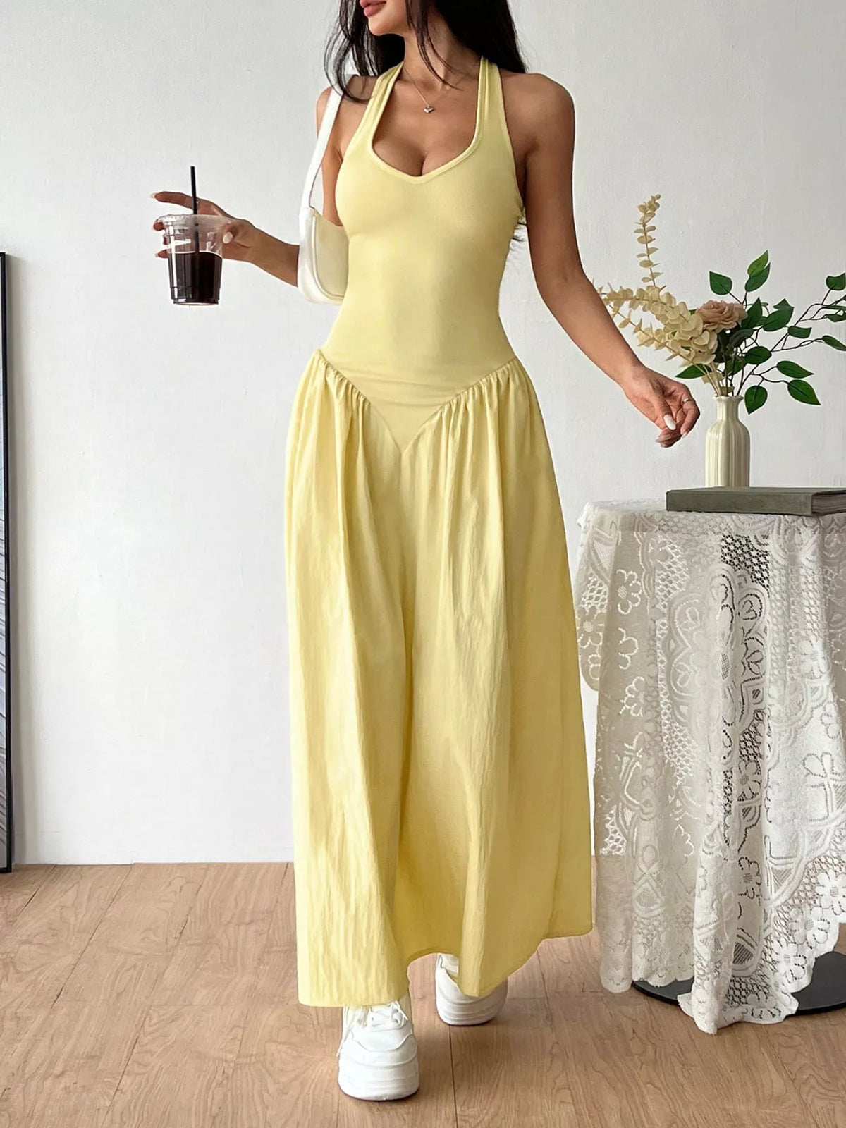Side view of the Elowen yellow halter maxi dress