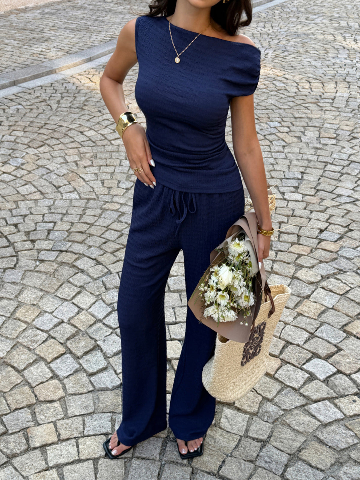 Navy matching asymmetrical neck top and pants set detail