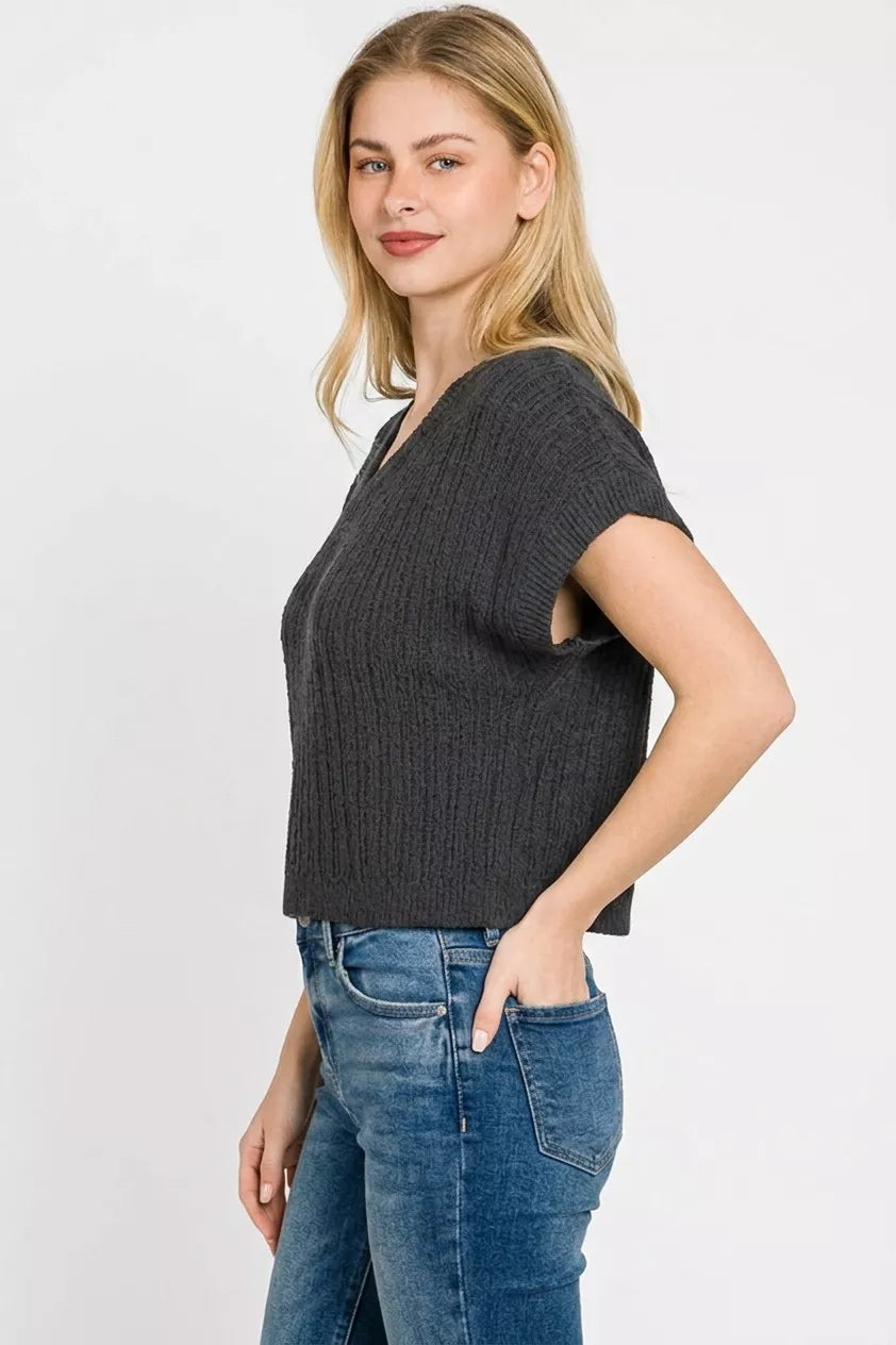 Black cropped sweater styled for evening