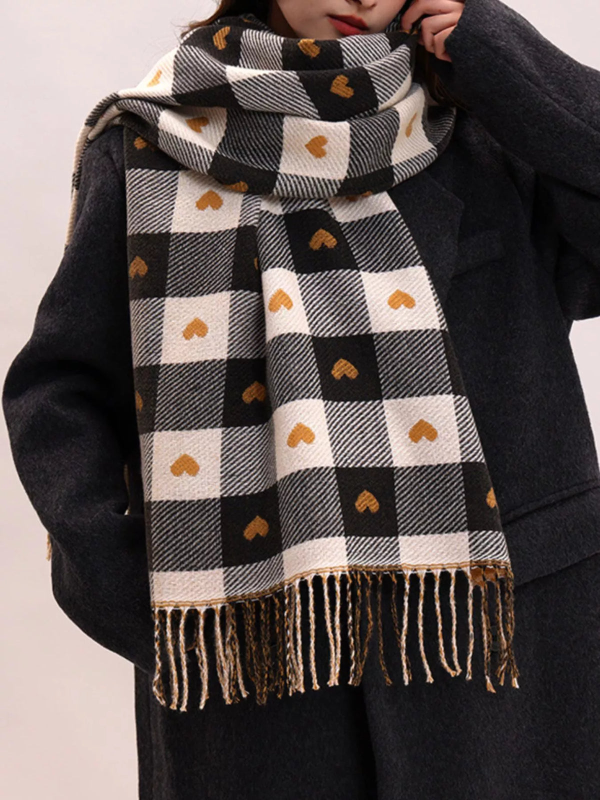 Heart print plaid scarf draped over the shoulders