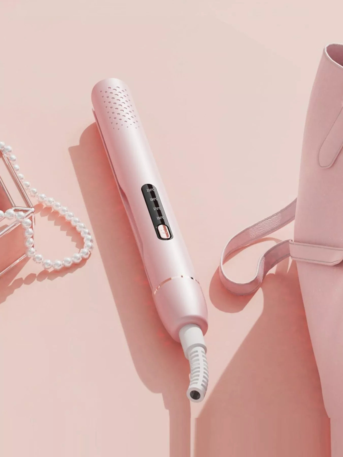 Black hair straightener held in hand