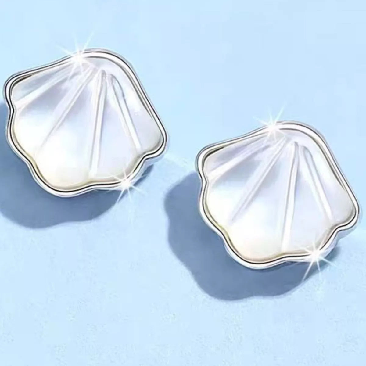Shell stud earrings shown against a plain ground