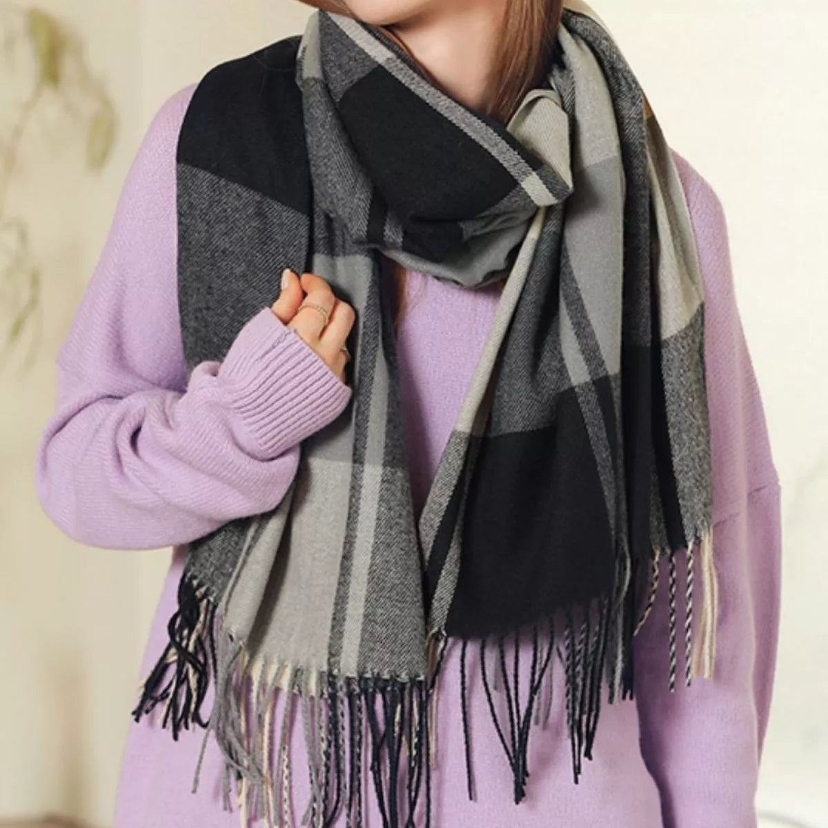 Close view of the plaid pattern on the fringe scarf