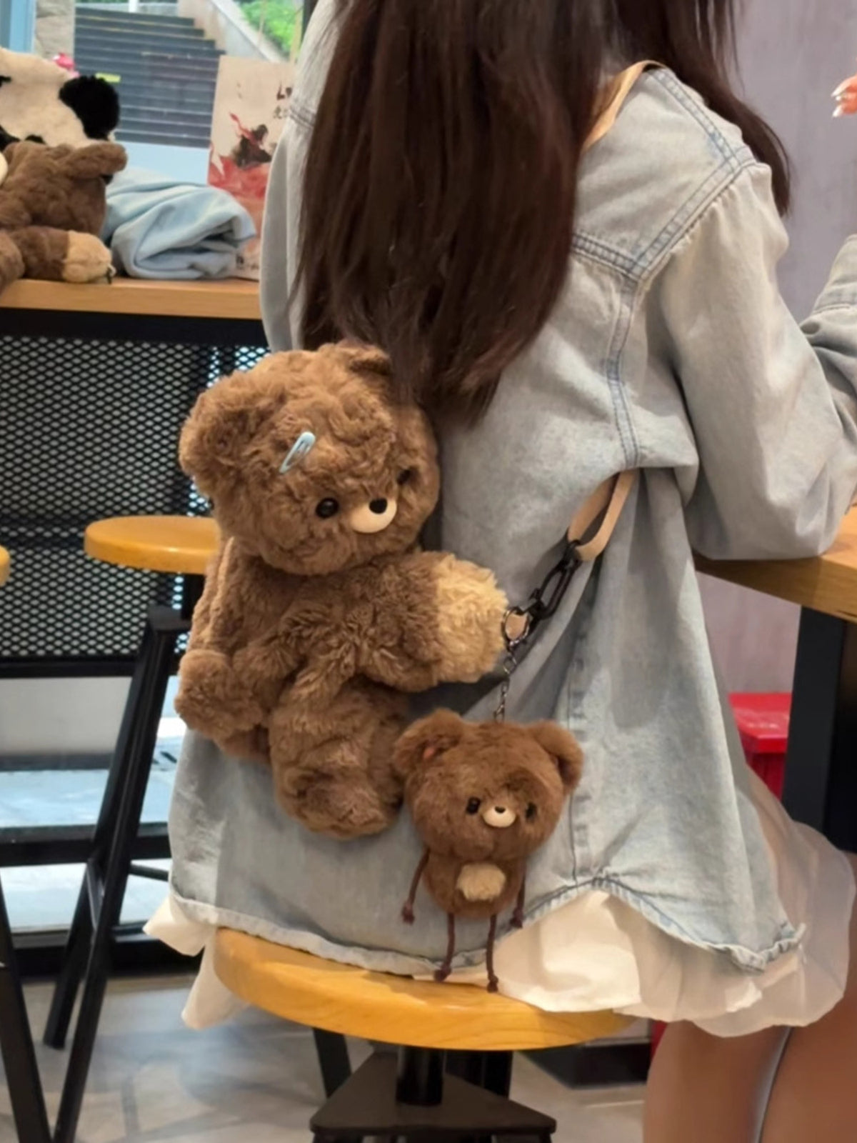 Dark brown plush teddy bear backpack worn on the shoulders
