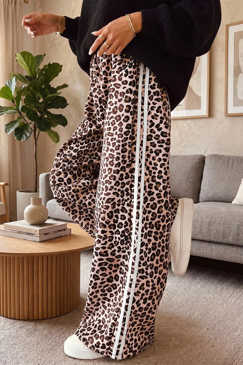 Wide leg leopard print pants shown from the side on a model