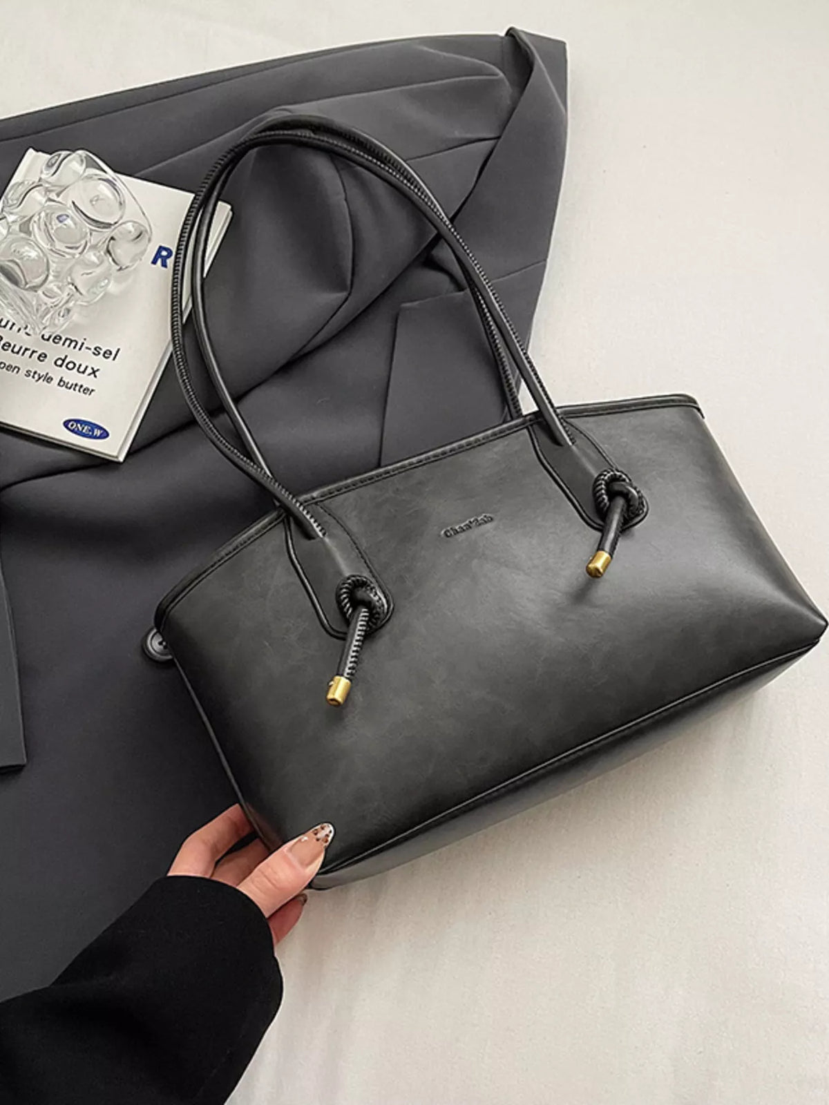 Leather shoulder bag held by model