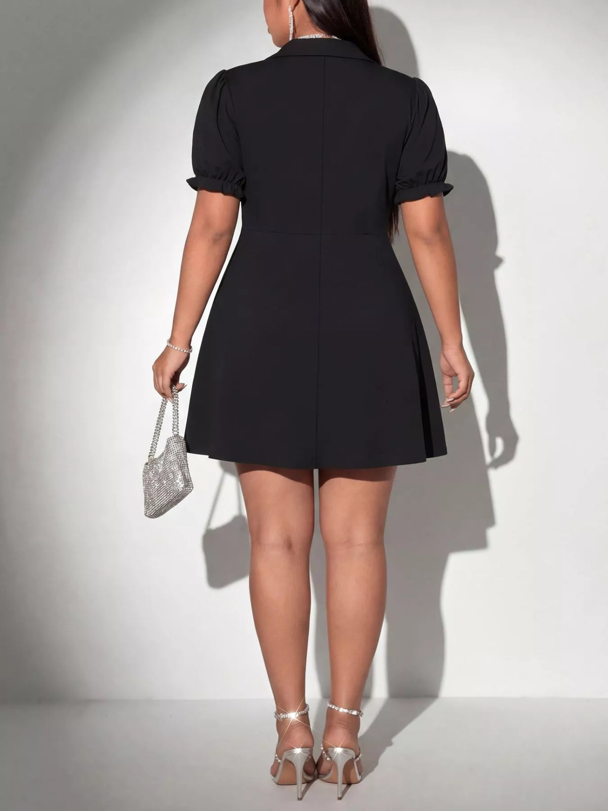 Plus size black surplice mini dress styling detail