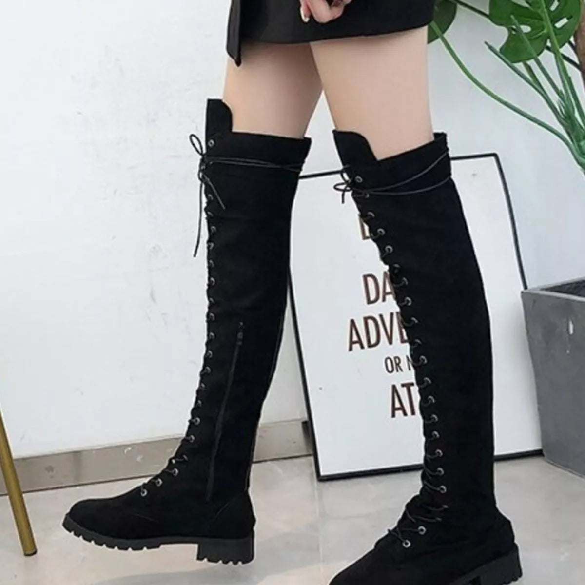 Lace up over the knee boots styled with jeans