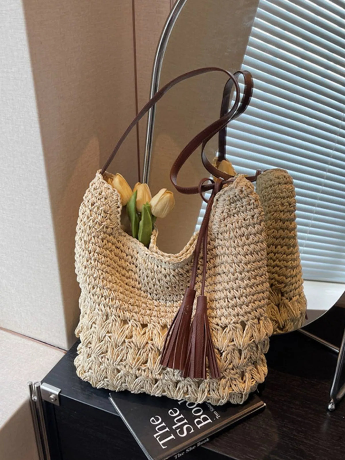 Close up of woven straw texture on cream bag