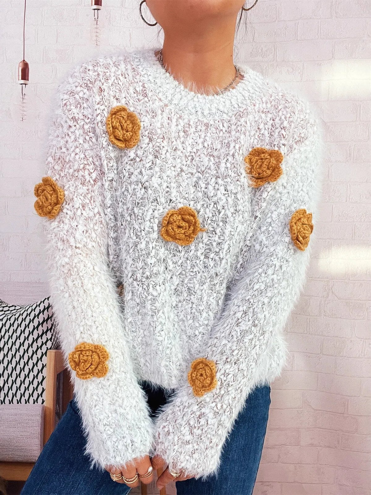 Flower embellished round neck sweater, neckline detail