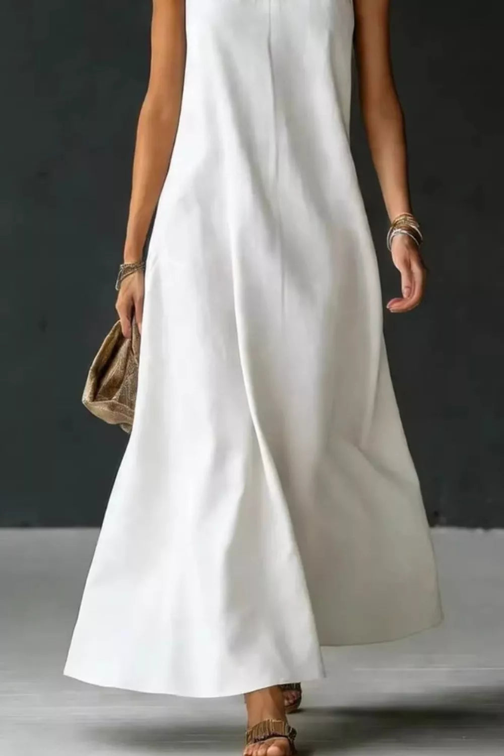 Halter neck sleeveless maxi dress with side slit movement shot
