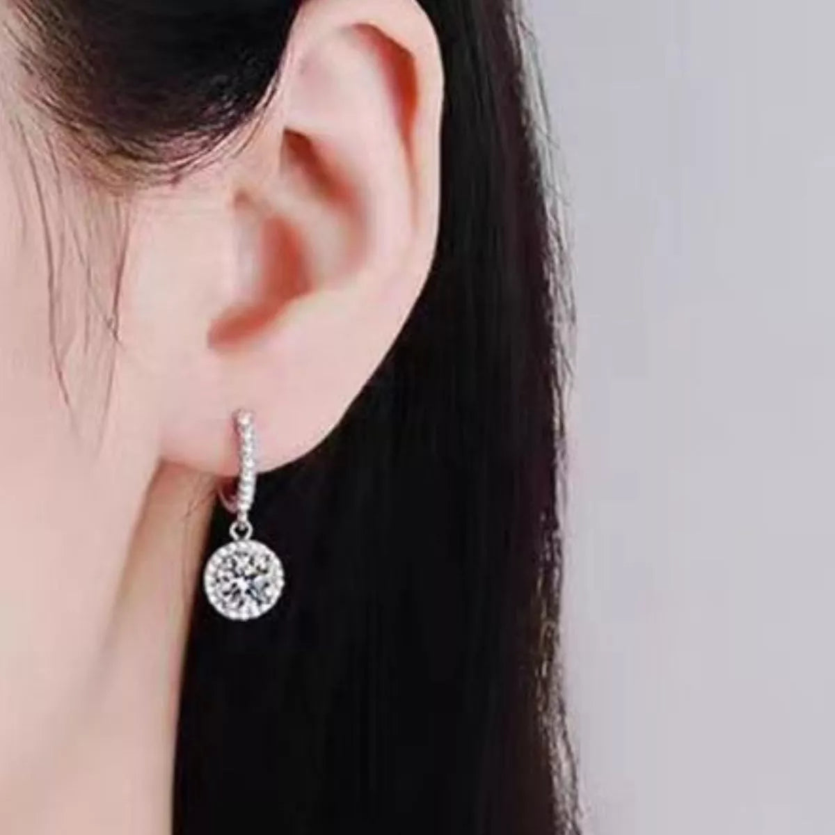 Pair of sterling silver hoop drop earrings side by side