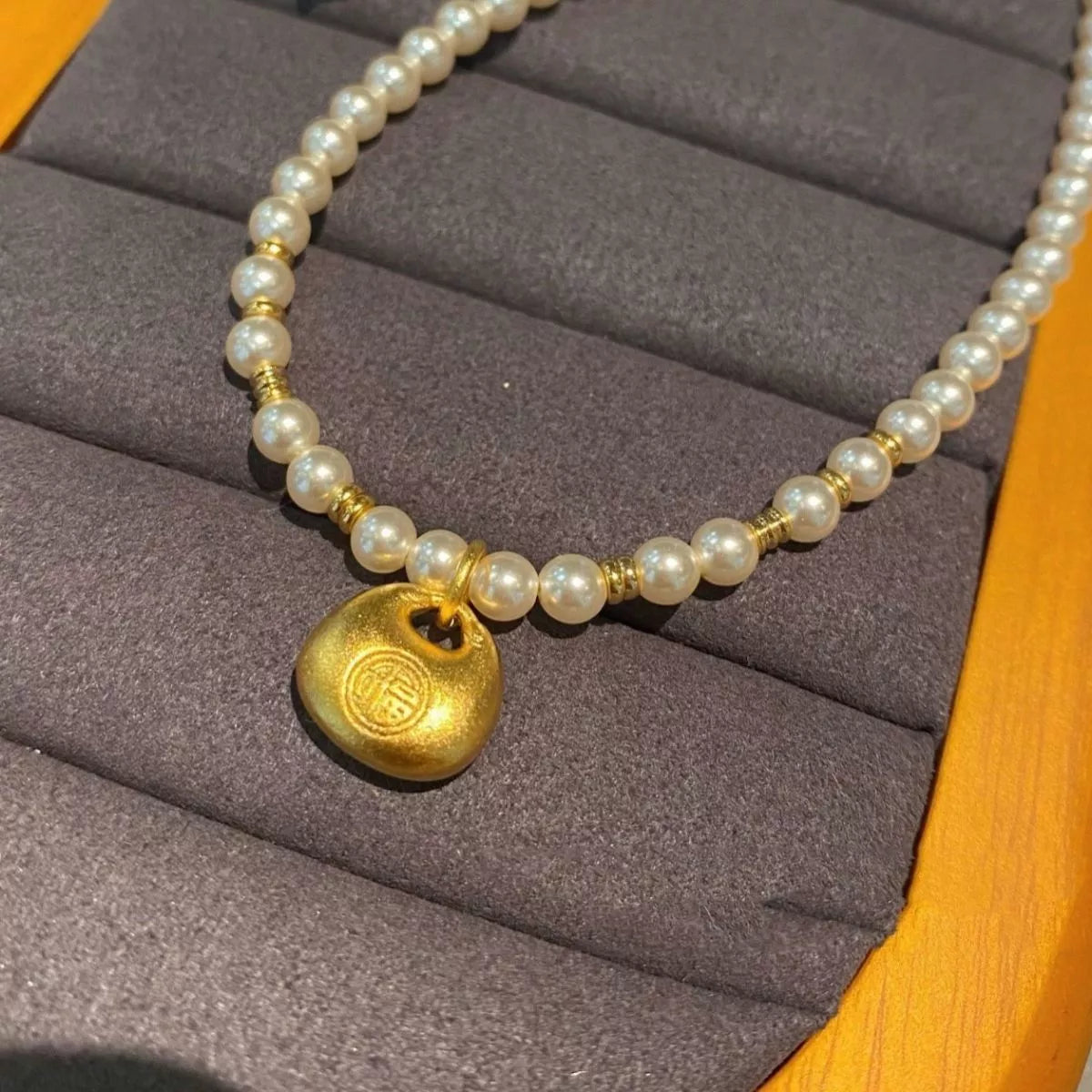 pearl necklace with gold pendant flat lay