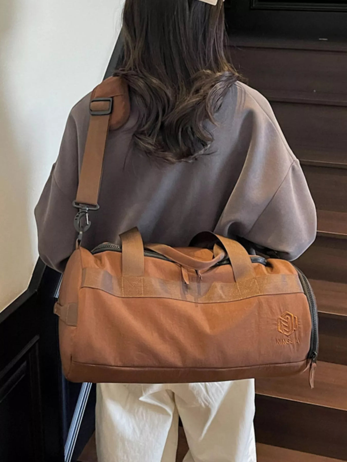 Brown duffel bag shoulder strap detail