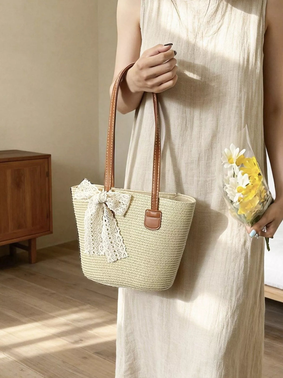 Close up of lace bow on straw bag