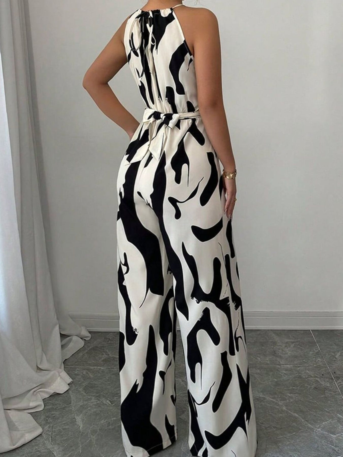 Close up of tie waist detail on wide leg jumpsuit