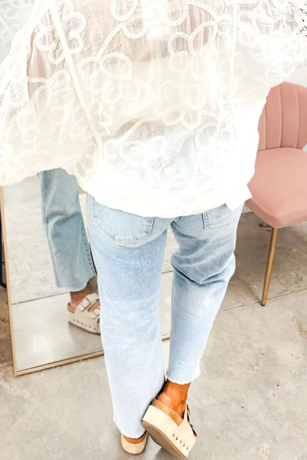 Raw hem detail on light wash straight jeans