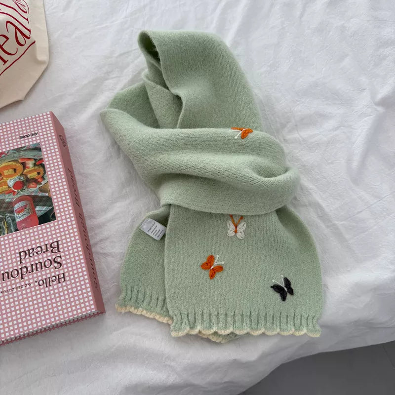 Butterfly embroidered scarf shown in a pastel shade
