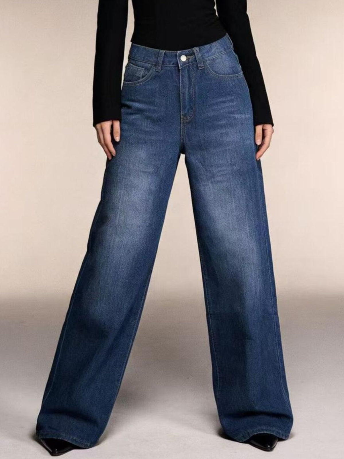 Full length styling of medium wash wide leg jeans