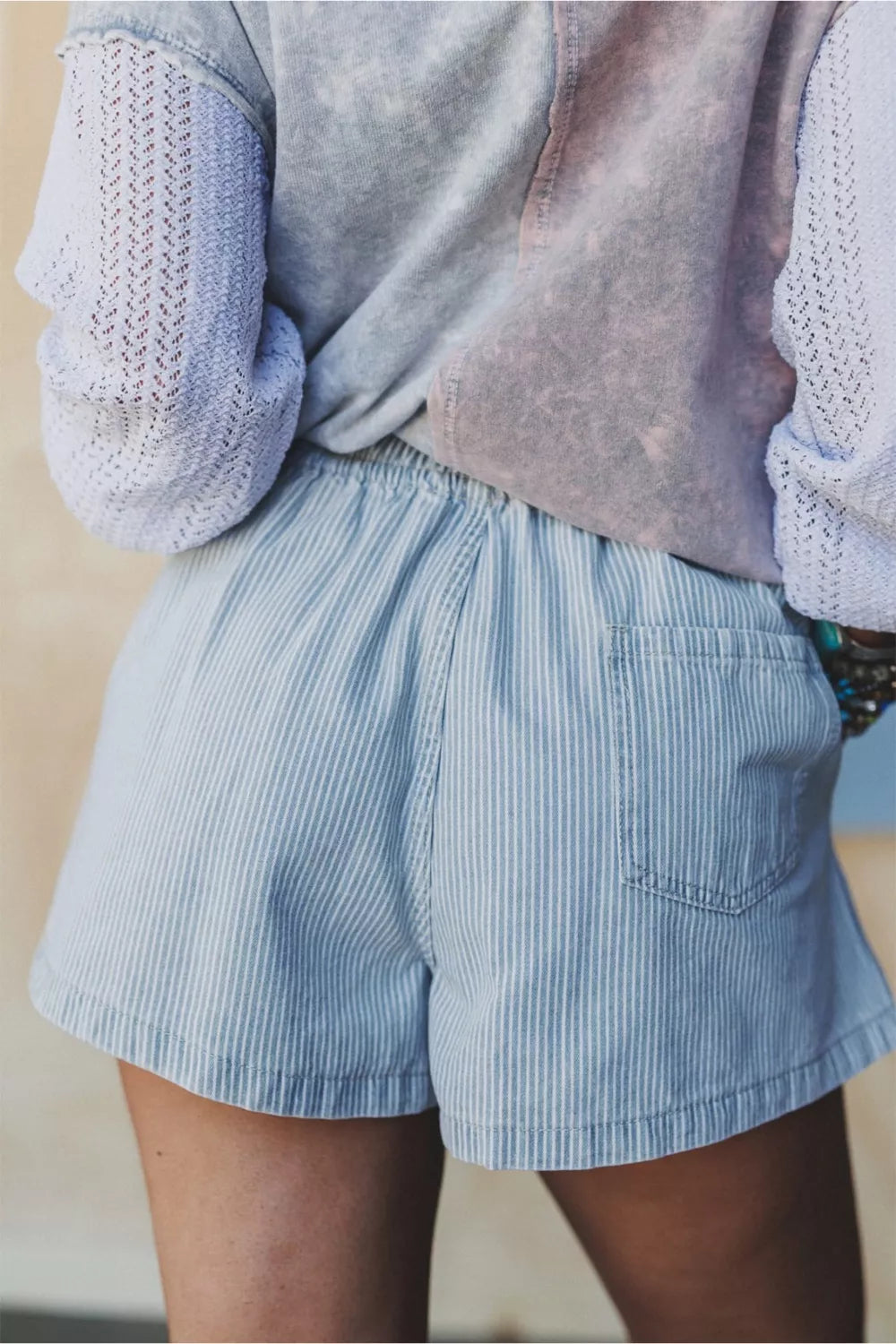Light blue striped drawstring shorts full length view
