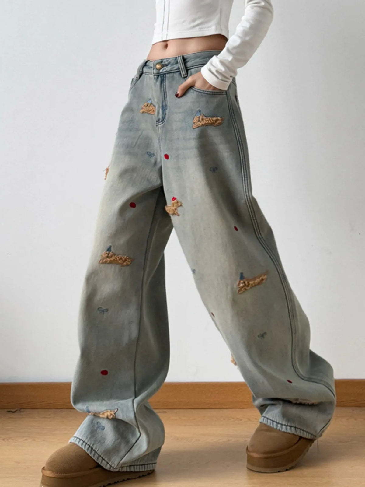 Model wearing embroidered wide leg jeans