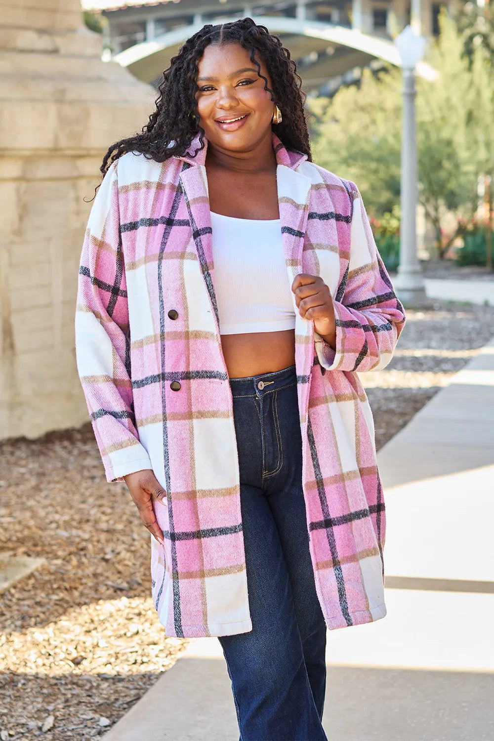 Plaid coat worn open over a sweater