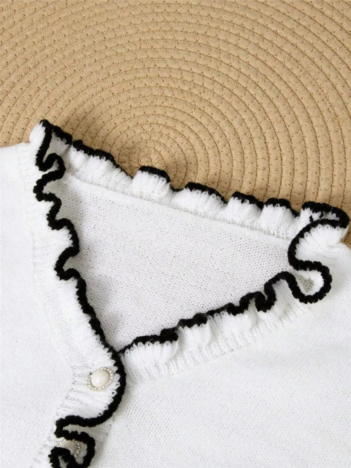 Ruffled trim button front sweater side view