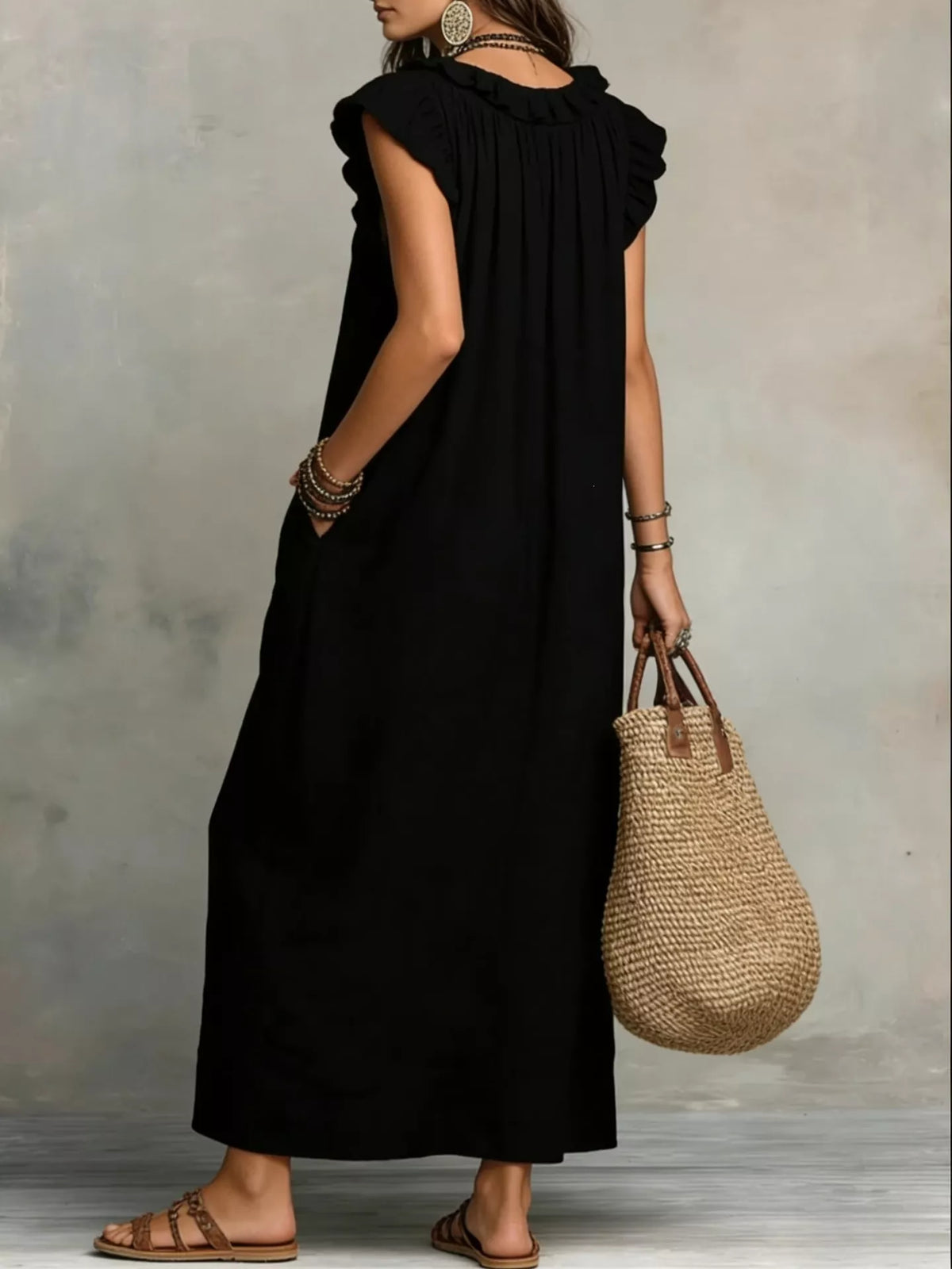 Maxi dress shown at a side angle with hand in the pocket