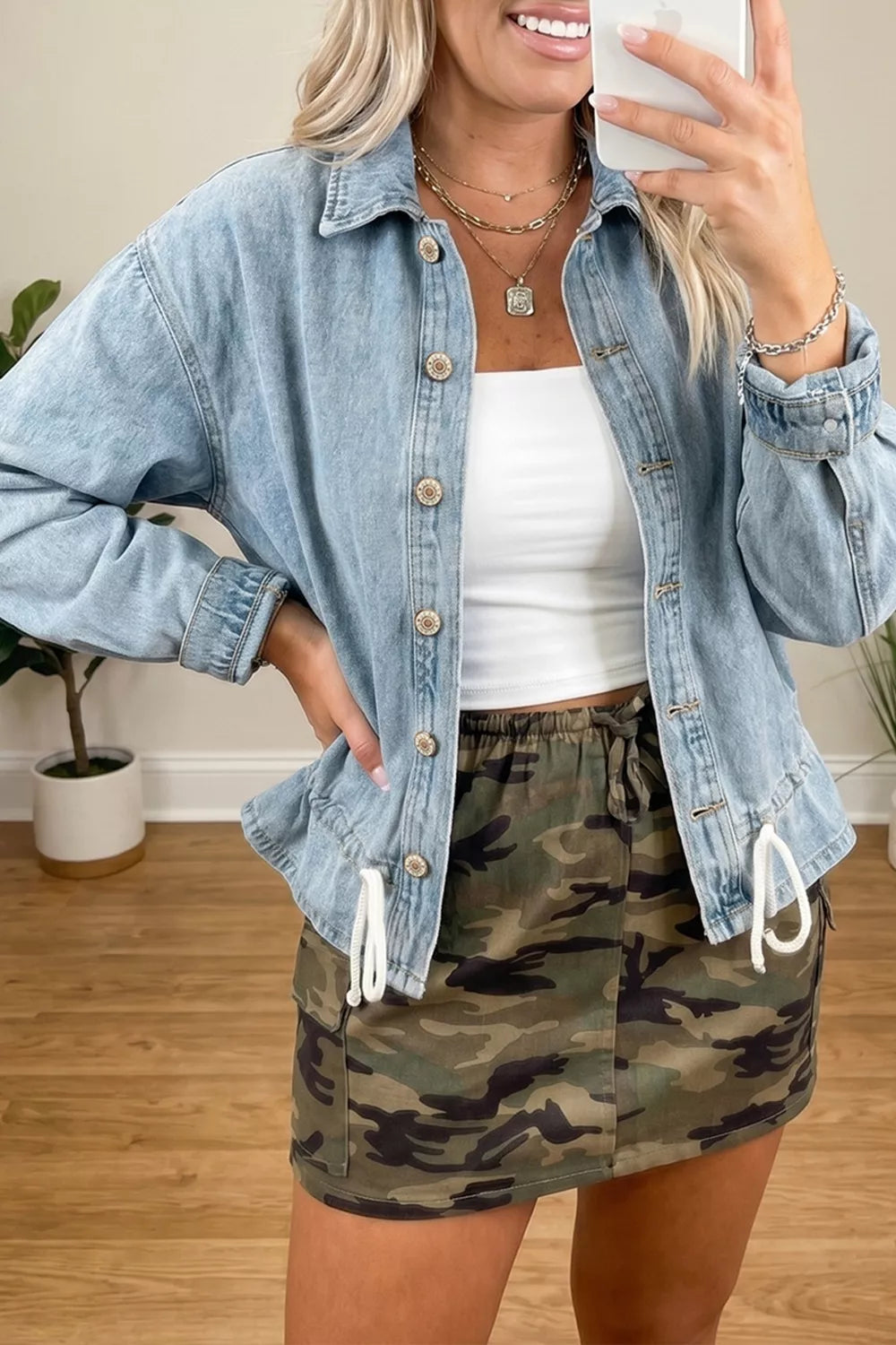 Light wash denim jacket with button front, worn open