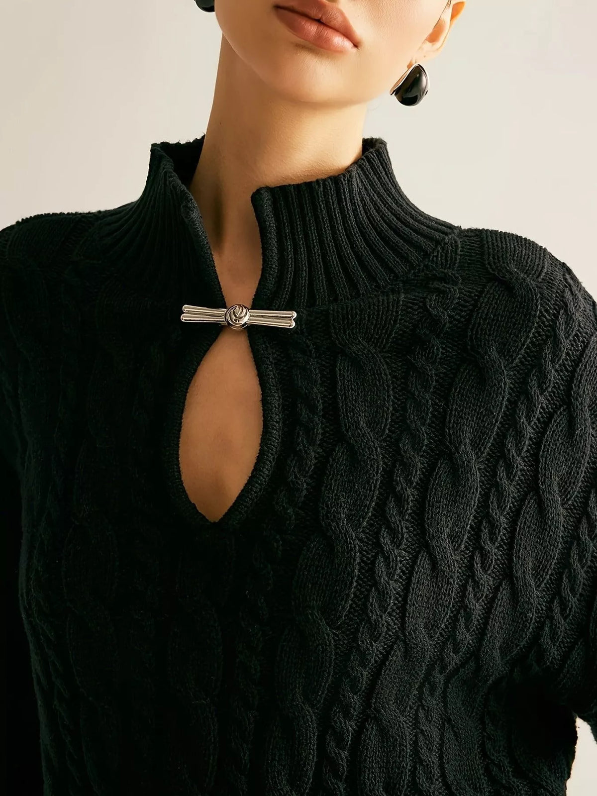 Black cable knit sweater styled on model