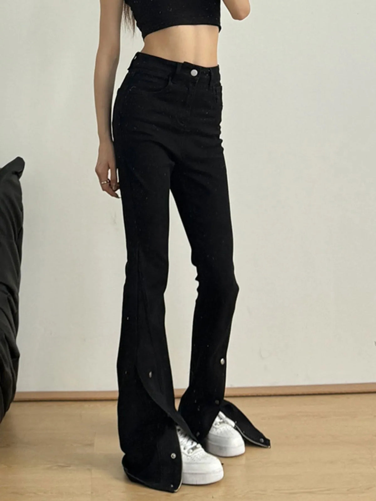 Black flare jeans showing front slit hem