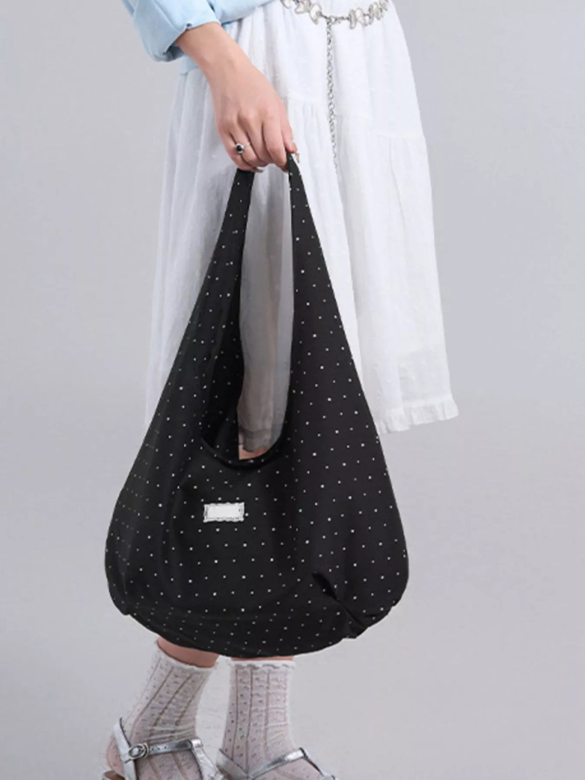 Polka dot canvas shoulder bag in black front view