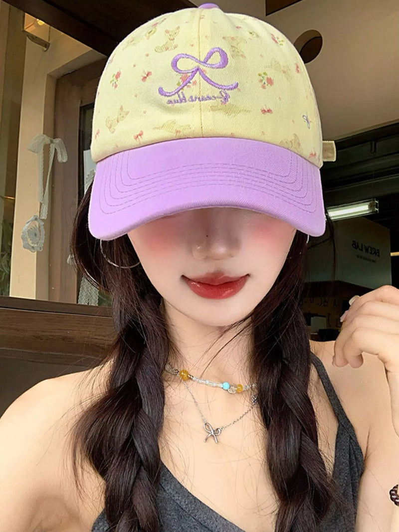 Bow embroidered baseball cap shown from the front