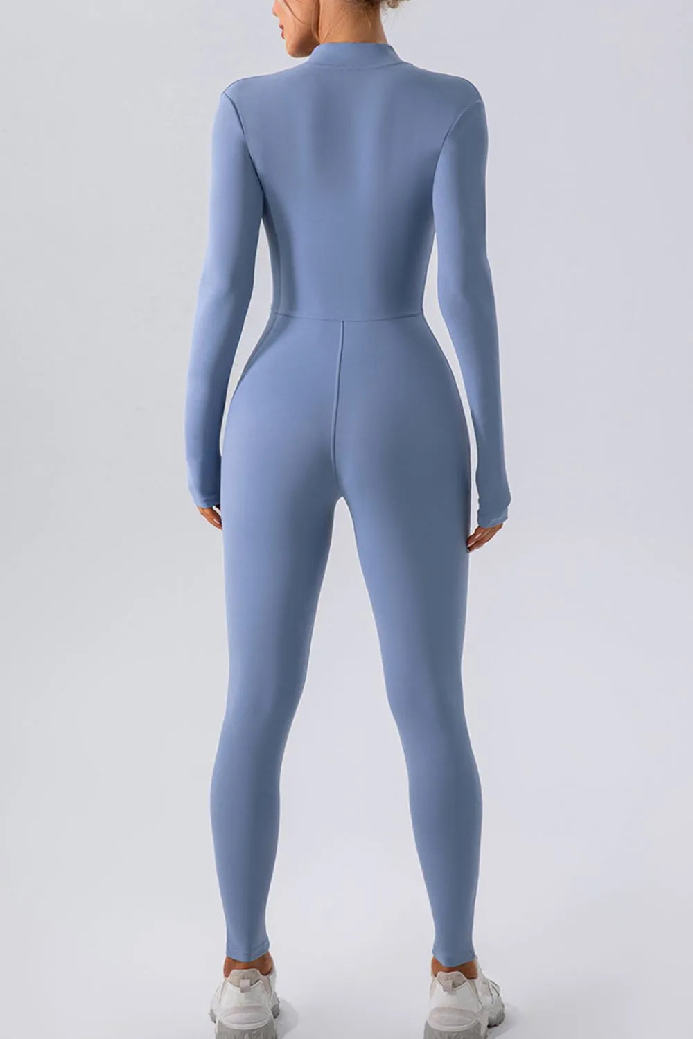Half zip mock neck active jumpsuit hem detail